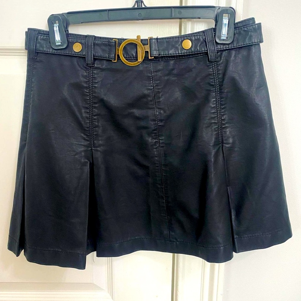 Free People black pleated mini skirt. Leather material. Size 4. Never worn. $35